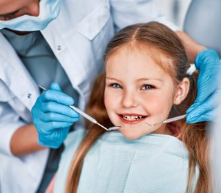 Photo,Of,A,Child,Smiling,At,A,Dentist,Appointment.,A